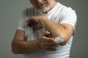 close-up-senior-man-using-cream